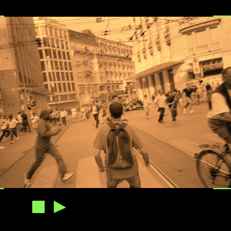 Photo of a man looking at a riot where everybody is running except him